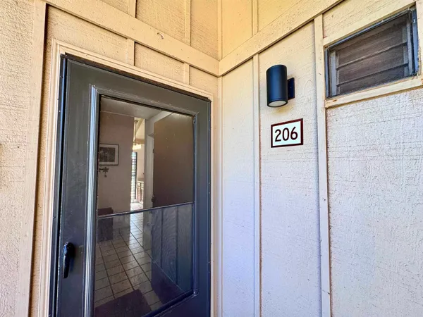 a view of a door and a street sign