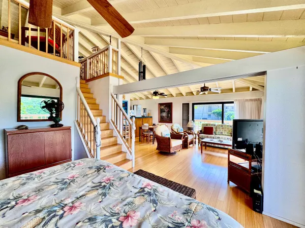 a bed room with a bed and a television