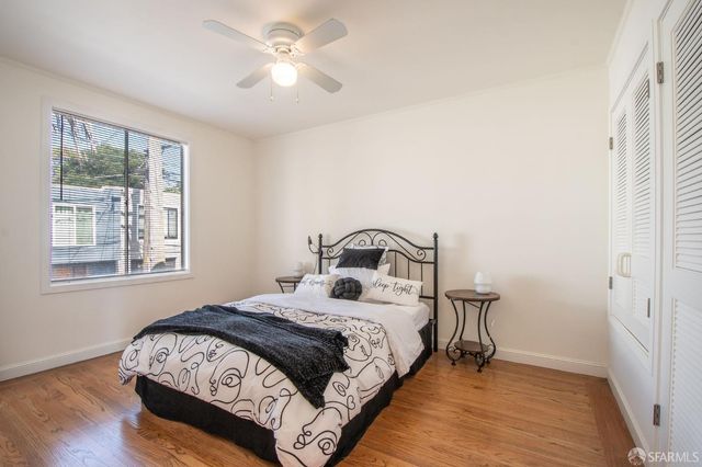 a bedroom with a large bed and a chandelier