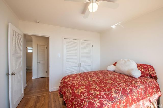 a view of a balcony with chairs and wooden floor