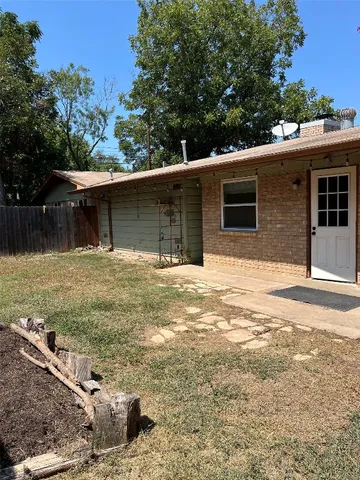 a view of a backyard with a tree