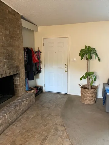 a view of living room filled with furniture and a potted plant