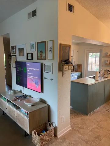 a kitchen with kitchen island stainless steel appliances a stove refrigerator and sink