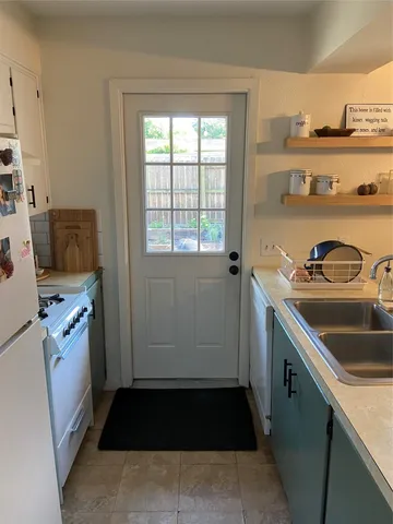 a utility room with sink dryer and washer