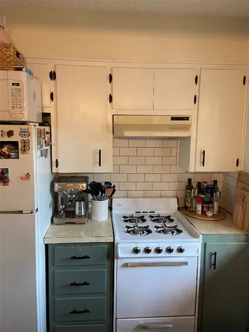 a kitchen with a stove and a refrigerator