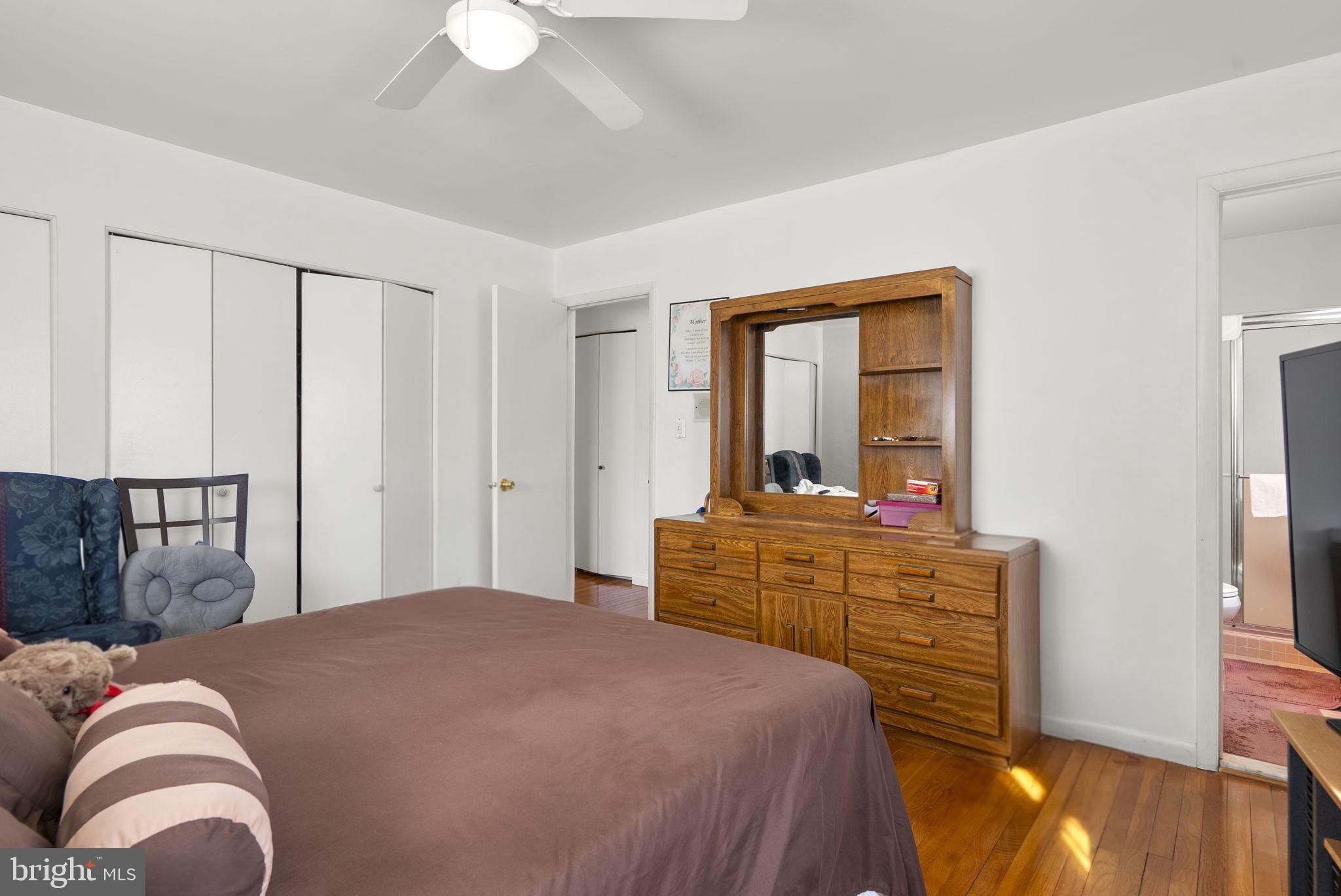 1408 Chilton Drive Silver Spring, MD 20904 - Photo 16 of 29 a bedroom with a bed and a chandelier