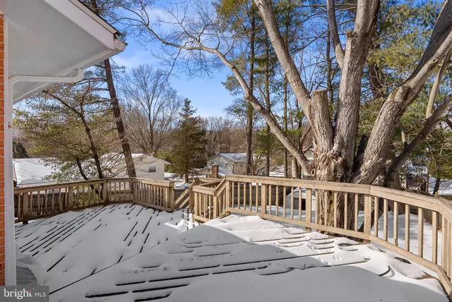 a view of a wooden deck with chairs and a yard