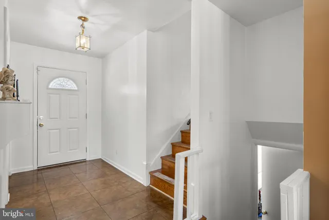 a view of entryway and hall with a chandelier