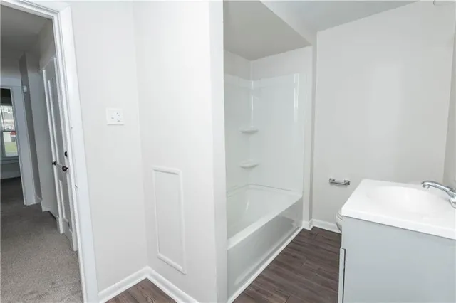 a bathroom with a tub and sink