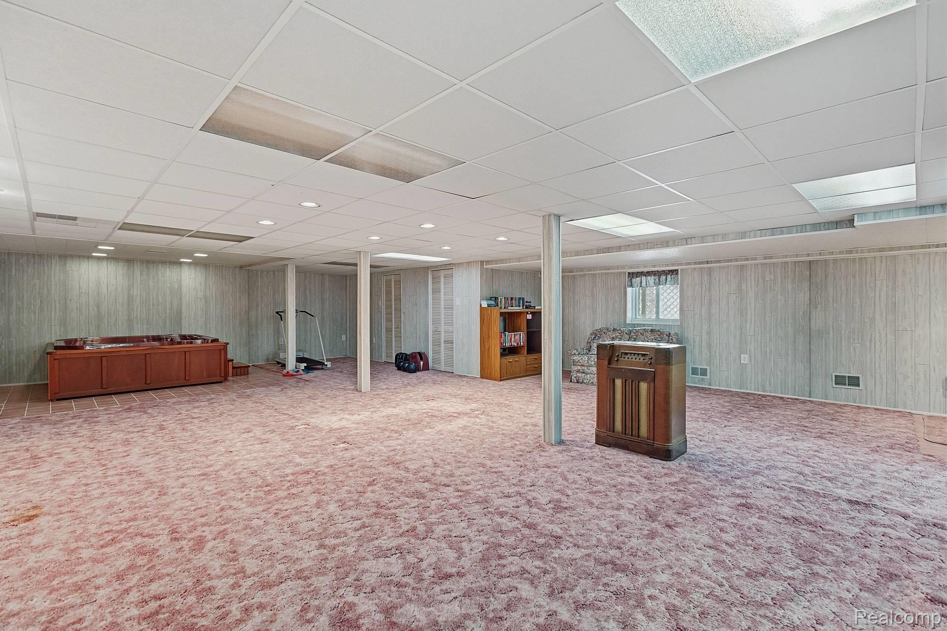 70919 Coon Creek Road Armada, MI 48005 - Photo 31 of 50 Finished below grade area with a paneled ceiling, wooden walls, and carpet flooring