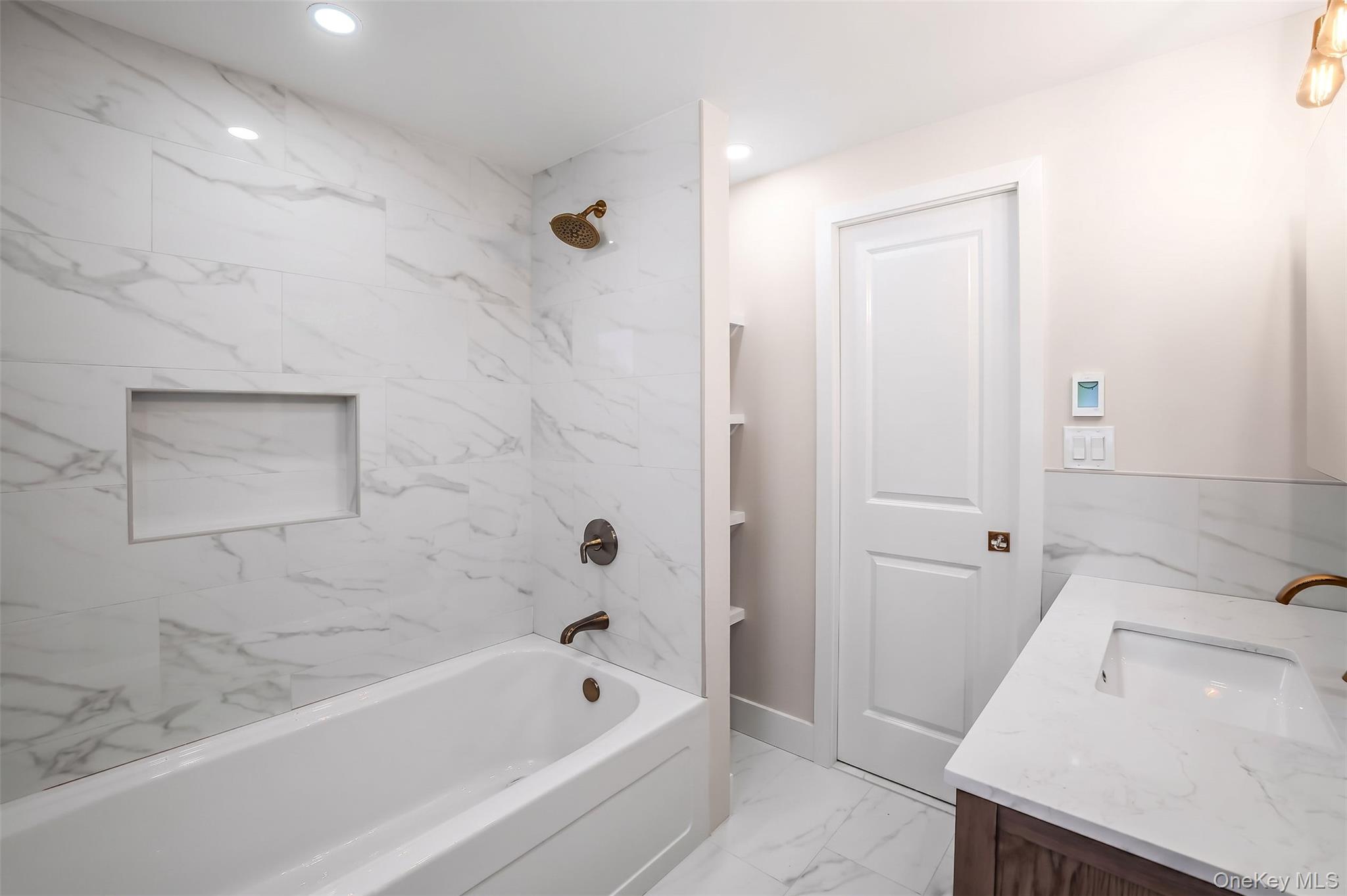 123 East Maple Street Valley Stream, NY 11580 - Photo 5 of 11 a bathroom with a sink a toilet and bathtub