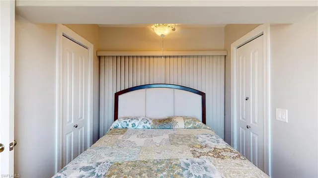 a bedroom with a bed and a large mirror