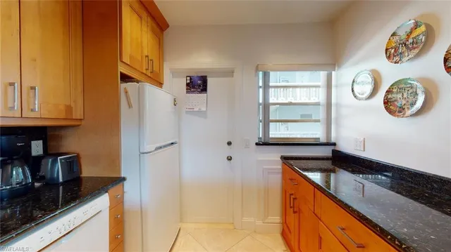 a kitchen with a refrigerator and a stove