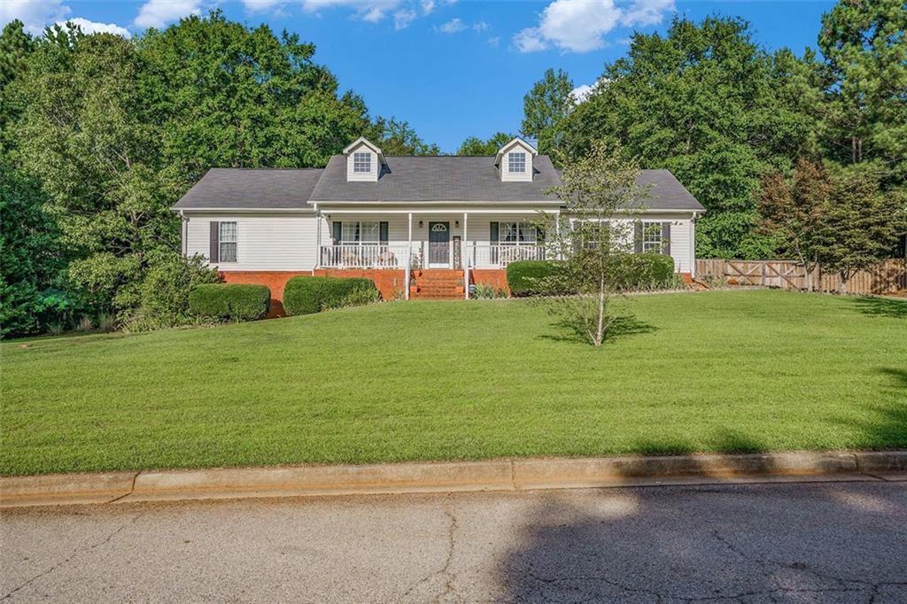 138 Cardell Farms Road Locust Grove, GA 30248 - Photo 1 of 1 a front view of a house with a garden