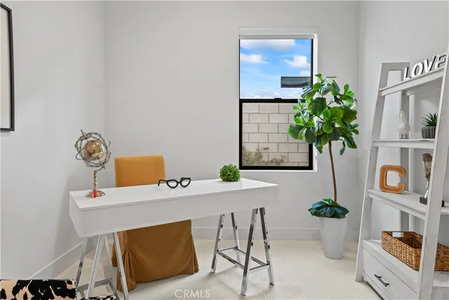 a living room with furniture and potted plant
