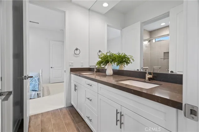 a spacious bathroom with a granite countertop sink and a mirror
