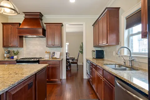 a open kitchen with stainless steel appliances granite countertop a stove and refrigerator