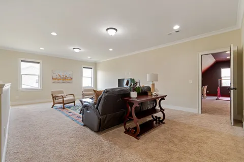 a bathroom with a granite countertop sink a toilet a mirror and shower
