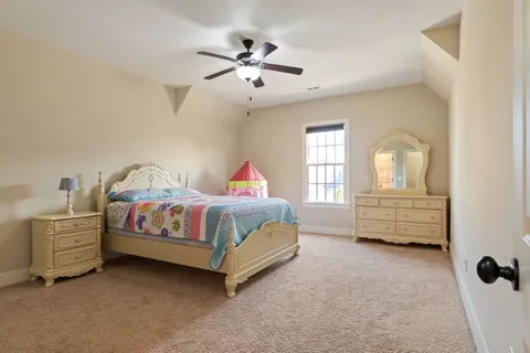 a view of a house with large windows and a yard