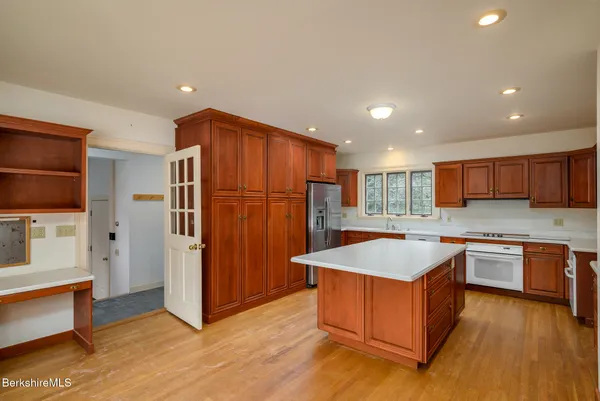 a kitchen with stainless steel appliances granite countertop a refrigerator a sink and a stove