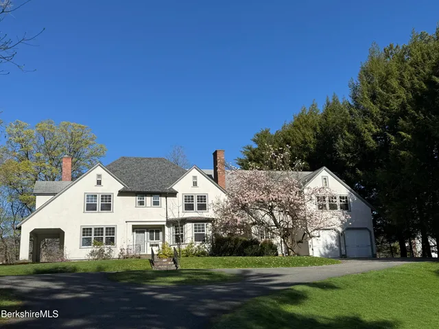a view of house with yard and green space