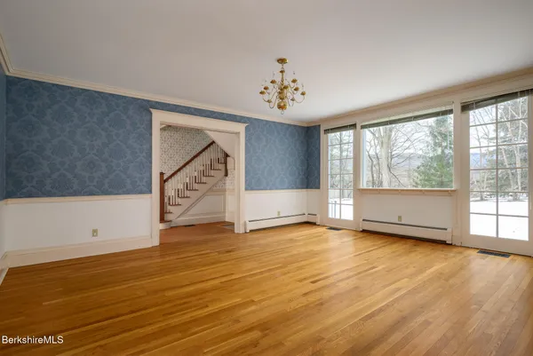 wooden floor in an empty room with a fireplace