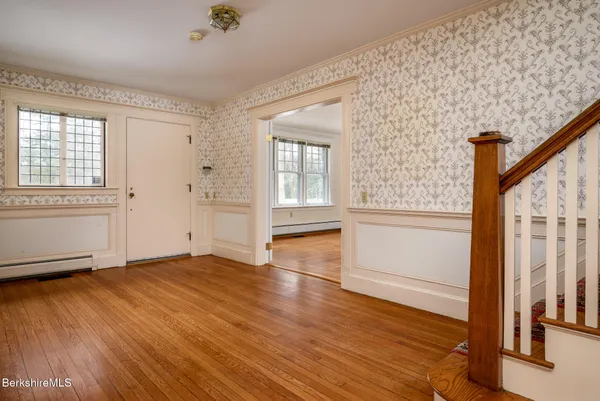 a view of an empty room with a fireplace and a window