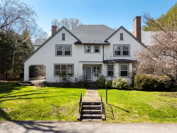 a front view of a house with garden