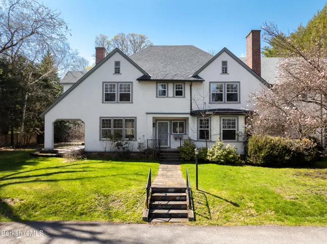 a front view of a house with a garden