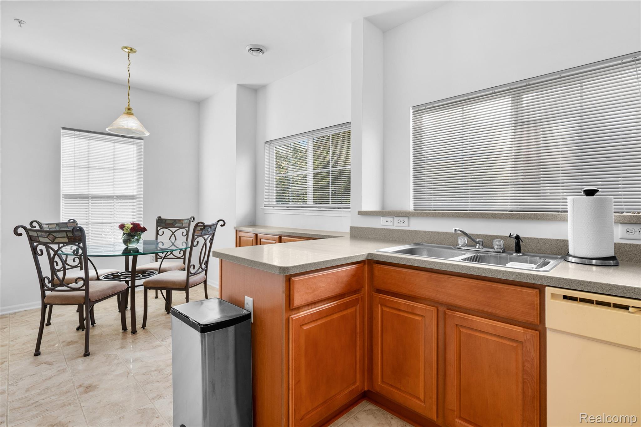 22730 Goddard Road Taylor, MI 48180 - Photo 22 of 34 Kitchen featuring dishwasher, hanging light fixtures, plenty of natural light, and brown cabinets