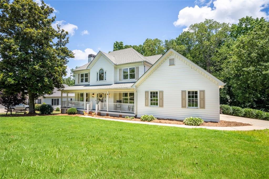 a front view of house with yard and green space
