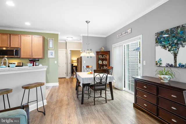 a living room with furniture and a large mirror with wooden floor
