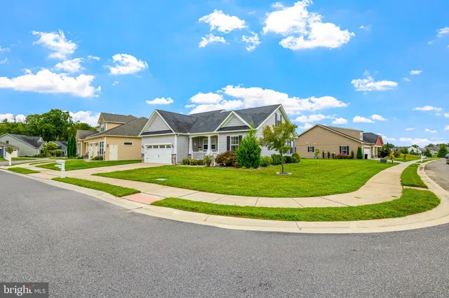 a view of a house with a yard and deck