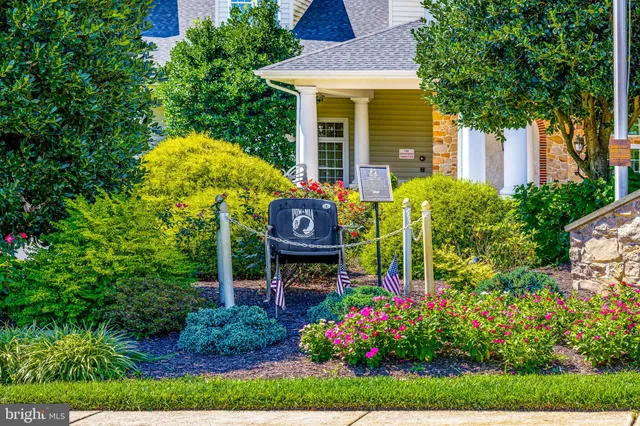a view of a houses with a yard from a balcony