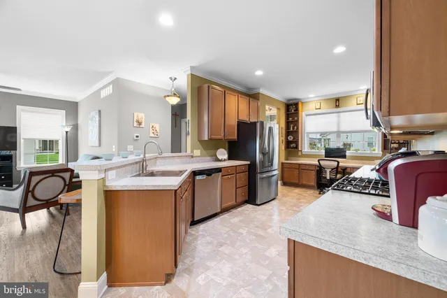 a kitchen with stainless steel appliances a refrigerator and a stove top oven