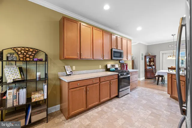 a kitchen with stainless steel appliances a stove refrigerator sink and cabinets