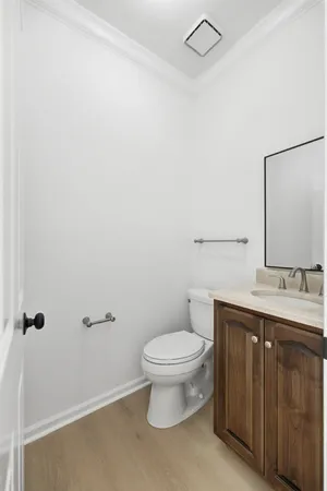 a bathroom with a granite countertop toilet and a sink