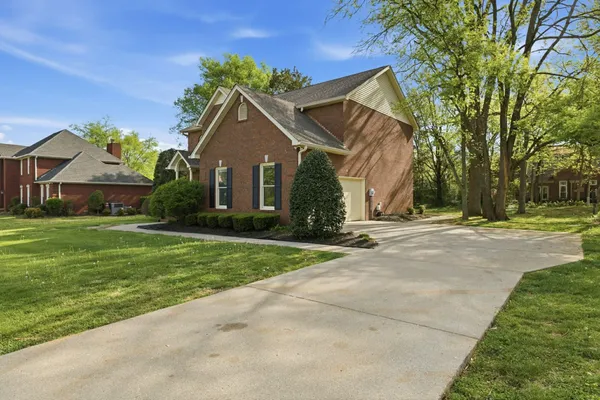 a front view of house with yard and green space
