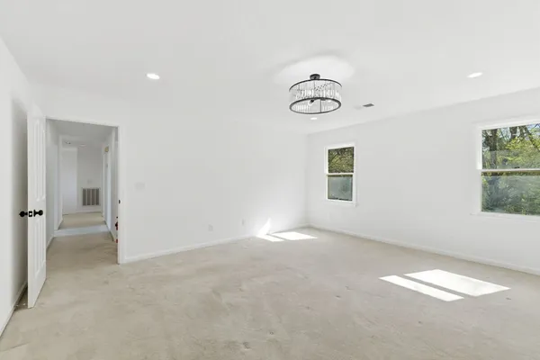 an empty room with windows and painted walls