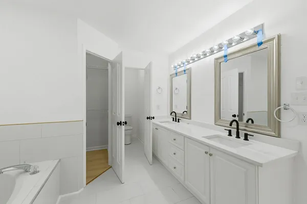 a bathroom with a double vanity sink mirror and shower