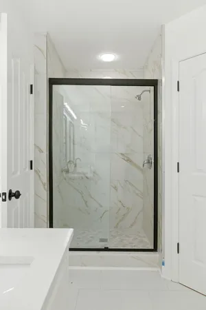 a bathroom with a bathtub and shower