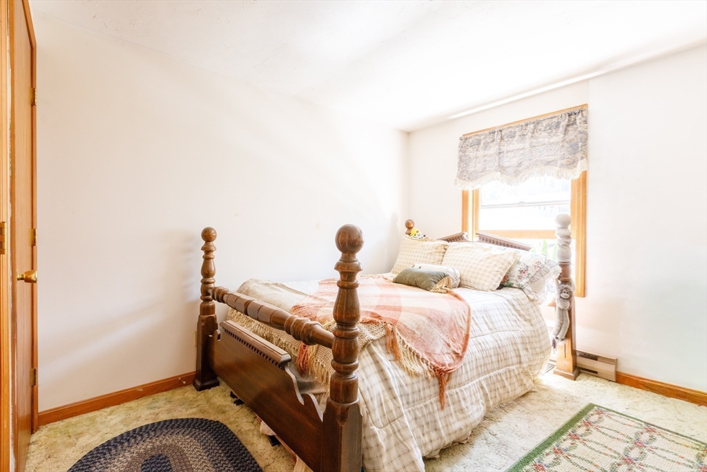 170 Perry Avenue, Unit 3A Worcester, MA 01610 - Photo 12 of 16 a bedroom with a bed and wooden floor