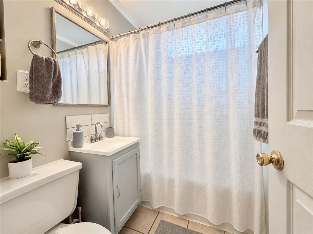 1909 Northview Avenue Anderson, SC 29625 - Photo 13 of 21 This bright bathroom features a vanity, mirror, and toilet, complete with a shower.