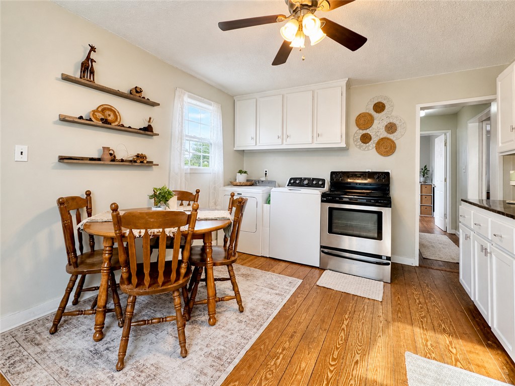 1909 Northview Avenue Anderson, SC 29625 - Photo 15 of 21 Bright and airy, this eat-in kitchen features warm wood flooring and convenient laundry appliances.