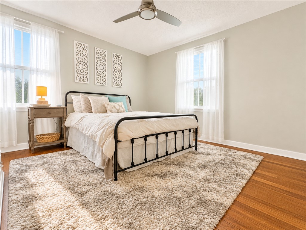 1909 Northview Avenue Anderson, SC 29625 - Photo 8 of 21 This spacious bedroom features ample natural light, a ceiling fan, and hardwood flooring.