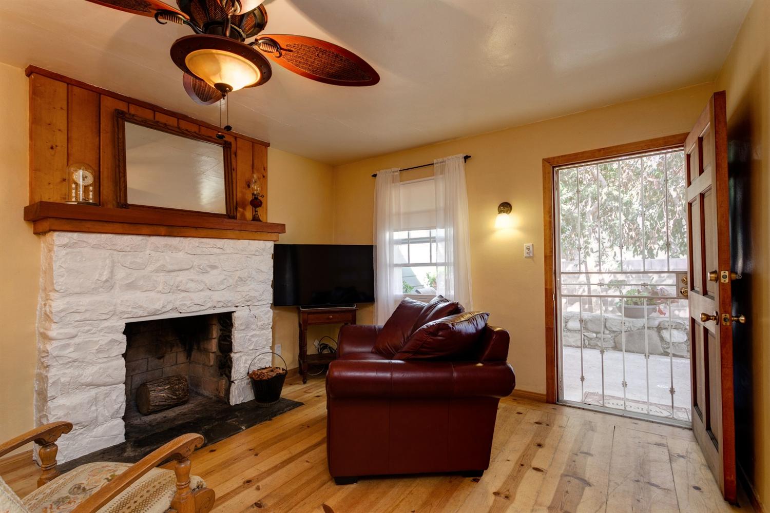 195 Grapevine Road Oak View, CA 93022 - Photo 3 of 41 a living room with furniture a fireplace and a flat screen tv