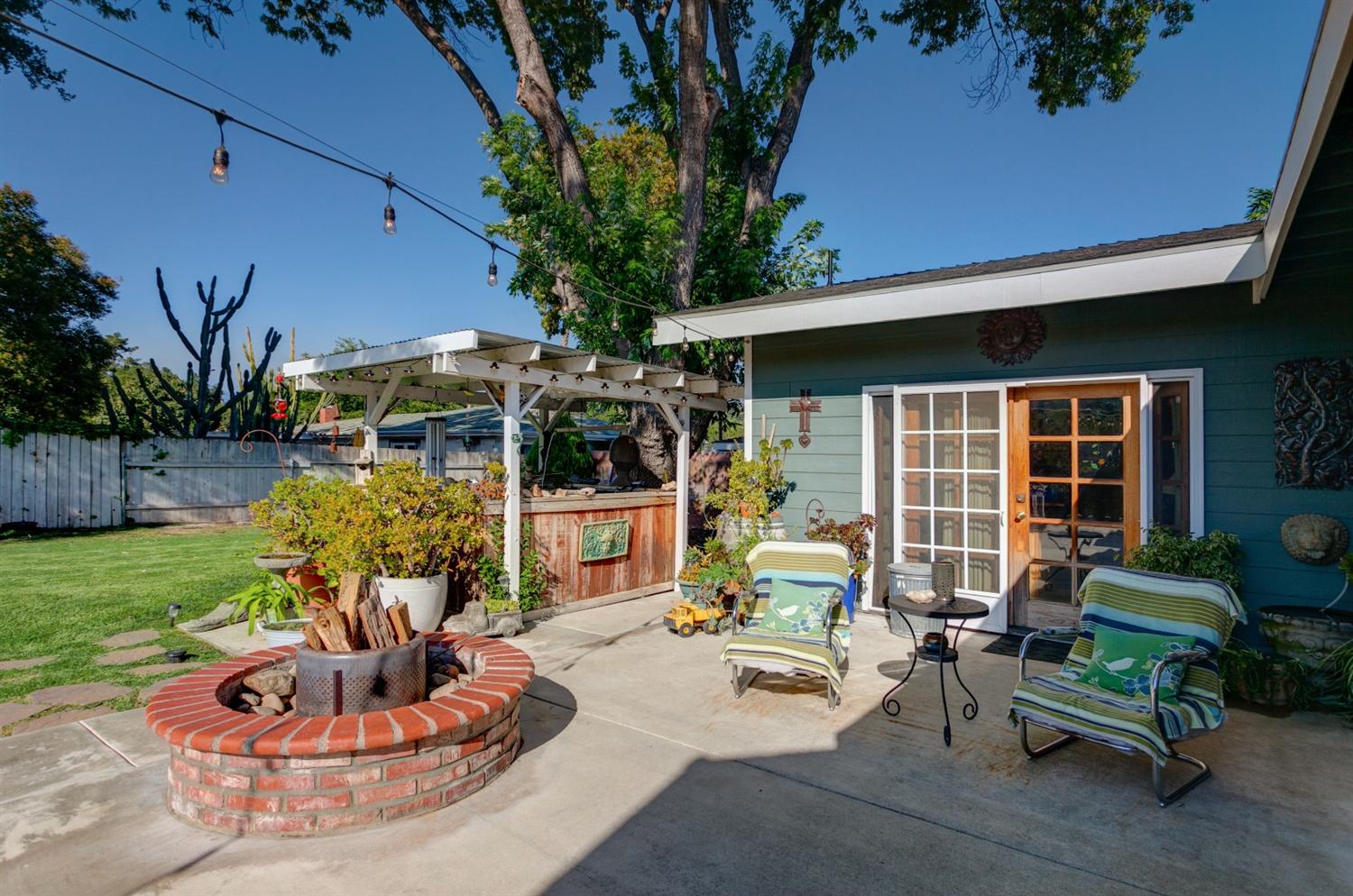195 Grapevine Road Oak View, CA 93022 - Photo 31 of 41 a view of a backyard with table and chairs potted plants and a fountain
