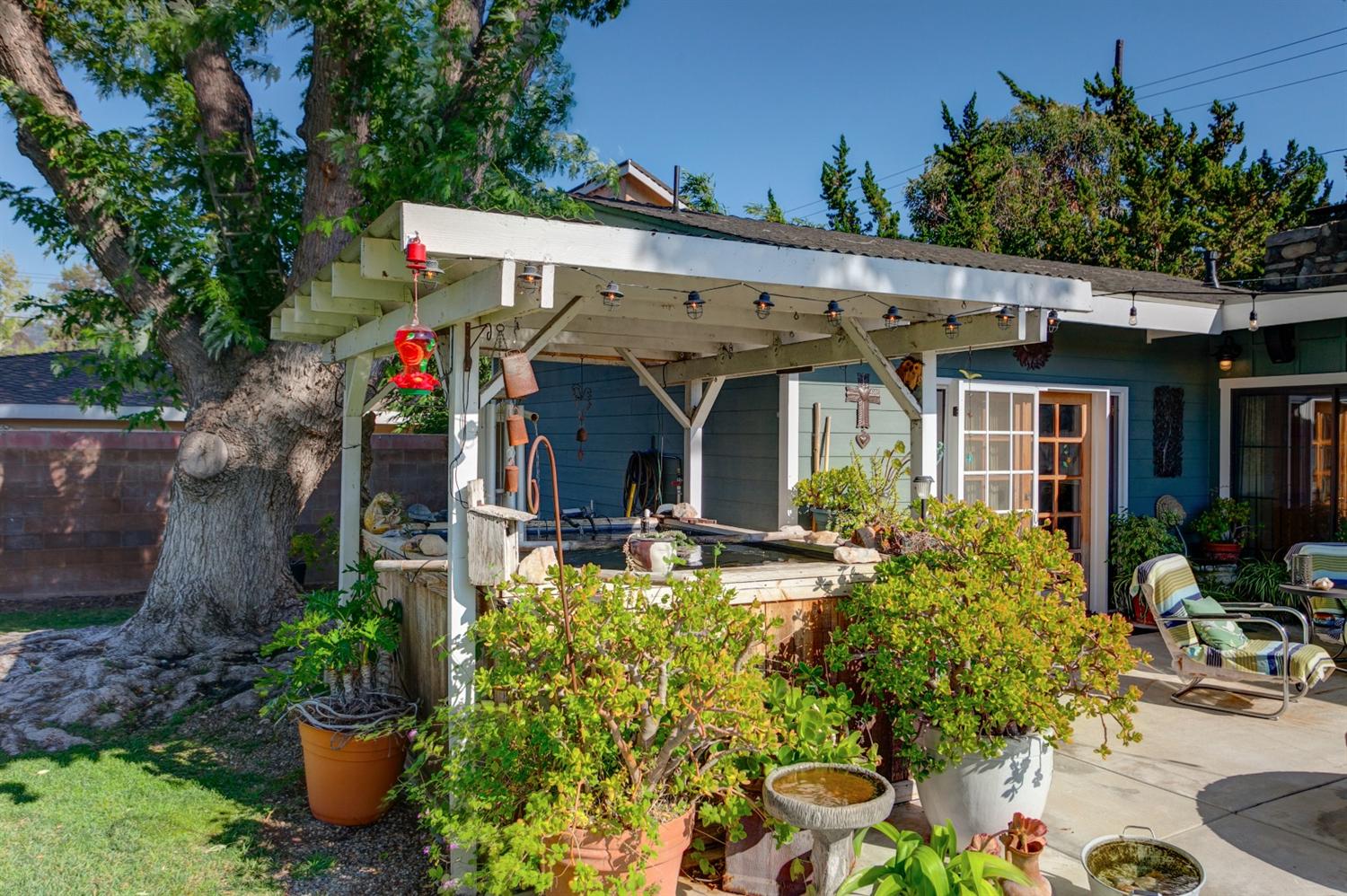 195 Grapevine Road Oak View, CA 93022 - Photo 32 of 41 a view of a patio with table and chairs potted plants and large tree