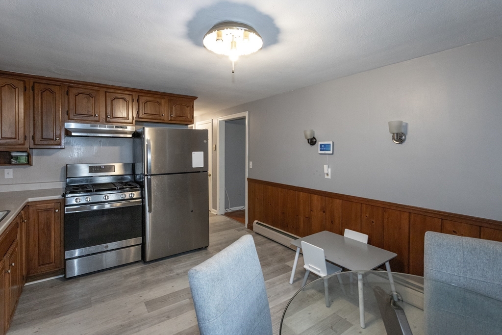 67 Donbray Road Springfield, MA 01119 - Photo 6 of 36 a kitchen with stainless steel appliances granite countertop a refrigerator and a stove top oven