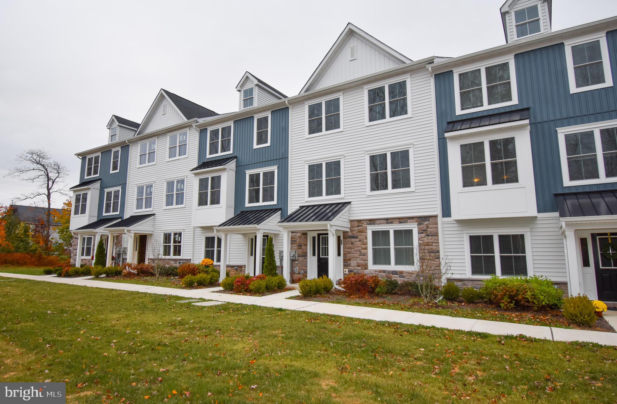 a front view of a residential apartment building with a yard
